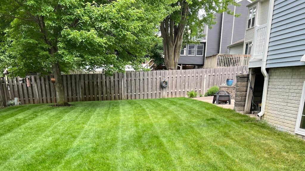 Freshly mowed striped lawn beside a home